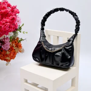 Black color momo Bag with flower in background